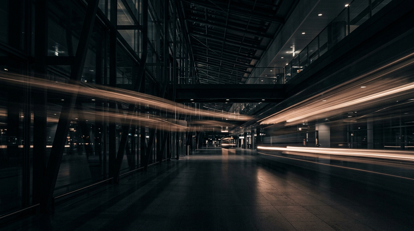 An airport terminal at night rendered as streaks of warm light and dark glass